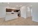 Bright kitchen features dark cabinetry, stainless steel appliances, and an island with a breakfast bar at 200 Feltrim Reserve Blvd, Davenport, FL 33837