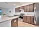 Kitchen featuring stainless steel appliances, a double sink, and dark wood cabinetry with light countertops at 200 Feltrim Reserve Blvd, Davenport, FL 33837