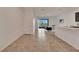 Open-concept living area featuring tile floors and access to the kitchen and sliding glass doors to lanai at 200 Feltrim Reserve Blvd, Davenport, FL 33837