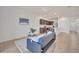 Open-concept living room showcases a couch, modern decor, and views of the kitchen area at 200 Feltrim Reserve Blvd, Davenport, FL 33837