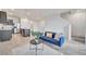 An open floor plan features a comfortable couch with bright pillows and a view to the kitchen and stairway at 200 Feltrim Reserve Blvd, Davenport, FL 33837