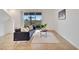 Comfortable living room featuring a modern couch, neutral rug, and sliding glass doors to the outside at 200 Feltrim Reserve Blvd, Davenport, FL 33837