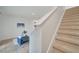 Carpeted stairs leading to the upper level with a view of the modern living room at 200 Feltrim Reserve Blvd, Davenport, FL 33837