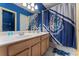 Charming bathroom with blue striped walls, double sink vanity, and Harry Potter themed shower curtain at 2041 Lacie Jo Ln, Kissimmee, FL 34743