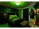 Themed bedroom with green walls, decorative accents, and a draped bed, creating a unique atmosphere at 2041 Lacie Jo Ln, Kissimmee, FL 34743
