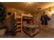 Themed bedroom features a wood bunk bed with decor and custom wall textures and decorations at 2041 Lacie Jo Ln, Kissimmee, FL 34743
