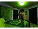 Themed bedroom with Slytherin decor, draped curtains, and green lighting for a unique immersive experience at 2041 Lacie Jo Ln, Kissimmee, FL 34743