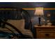 Comfortable bedroom featuring custom constellations, stylish lamp, and wooden nightstand at 2041 Lacie Jo Ln, Kissimmee, FL 34743