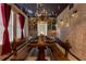 Unique dining room features stone walls, floating candles and a rustic wooden table with bench seating at 2041 Lacie Jo Ln, Kissimmee, FL 34743