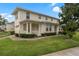 Inviting two-story home with a landscaped lawn and a cozy front porch with white columns at 2041 Lacie Jo Ln, Kissimmee, FL 34743