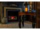 Themed fireplace featuring a stone-look surround, mantel decorations and a cozy faux logs at 2041 Lacie Jo Ln, Kissimmee, FL 34743