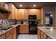 Kitchen with stainless steel appliances, granite countertops, mosaic backsplash and custom wooden cabinets at 2041 Lacie Jo Ln, Kissimmee, FL 34743