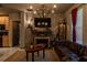 Living room with a decorative fireplace, unique light fixture, comfortable leather sofa, and themed decor at 2041 Lacie Jo Ln, Kissimmee, FL 34743
