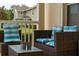 Inviting patio seating area with wicker furniture and blue striped pillows, perfect for relaxing outdoors at 2041 Lacie Jo Ln, Kissimmee, FL 34743