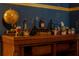 Eclectic display featuring a globe, antique bottles, and decorative items create a unique tabletop vignette at 2041 Lacie Jo Ln, Kissimmee, FL 34743