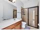 Bathroom features a walk-in shower, wood cabinets, and a large mirror at 2071 Remembrance Ave, St Cloud, FL 34769