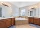 Bright bathroom features a soaking tub, double sink vanity, and modern fixtures at 2071 Remembrance Ave, St Cloud, FL 34769