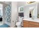 Well-lit bathroom includes a shower-tub combo, toilet, and wood vanity at 2071 Remembrance Ave, St Cloud, FL 34769