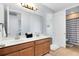 Bathroom featuring double sinks with wood cabinets and a shower-tub combo at 2071 Remembrance Ave, St Cloud, FL 34769
