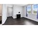 Bedroom with two windows, dark floors, a small dresser, and a closet at 2071 Remembrance Ave, St Cloud, FL 34769