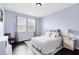 Peaceful bedroom with two windows, light blue walls and a white bed at 2071 Remembrance Ave, St Cloud, FL 34769