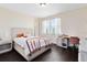 Cozy bedroom with light walls, dark wood floors, and lots of natural light at 2071 Remembrance Ave, St Cloud, FL 34769