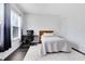 Clean and modern bedroom with a desk, chair, and a comfortable bed at 2071 Remembrance Ave, St Cloud, FL 34769