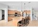 Kitchen featuring an island, stainless steel appliances, tile backsplash, and wood cabinets at 2071 Remembrance Ave, St Cloud, FL 34769