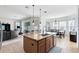 Large kitchen island featuring granite countertop, stainless steel appliances, and a breakfast bar at 2071 Remembrance Ave, St Cloud, FL 34769