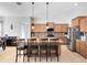 Spacious kitchen features granite countertops, stainless steel appliances, and an island with bar stool seating at 2071 Remembrance Ave, St Cloud, FL 34769