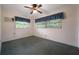 Bedroom with neutral walls, carpeted floor, ceiling fan, and natural light from two windows at 209 Wilmer Ave, Orlando, FL 32811