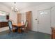 Cozy dining area featuring a classic chandelier, wooden table with seating, and ample natural light at 209 Wilmer Ave, Orlando, FL 32811
