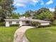 Inviting single-story home with well-maintained lawn, showcasing a private driveway and a cozy feel at 209 Wilmer Ave, Orlando, FL 32811