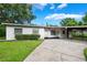 Traditional home with a well-kept lawn, showcasing an inviting carport and front entrance at 209 Wilmer Ave, Orlando, FL 32811
