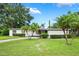 Charming single-story home with a well-manicured lawn and mature palm trees at 209 Wilmer Ave, Orlando, FL 32811