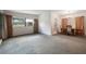 Spacious living room featuring large windows, neutral carpet, and an adjacent dining area at 209 Wilmer Ave, Orlando, FL 32811