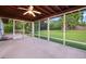 Screened patio with a stained wood ceiling and views of the manicured backyard at 209 Wilmer Ave, Orlando, FL 32811