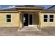 Exterior of a new home featuring a covered patio with a concrete slab and wooden support beams at 2292 Broadbrook Drive, St Cloud, FL 34771