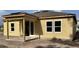 Exterior of a new home showing the side view with a covered patio and bare dirt lot at 2292 Broadbrook Drive, St Cloud, FL 34771