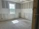Bedroom with new drywall, large window inviting natural light, and modern electrics at 2292 Broadbrook Drive, St Cloud, FL 34771