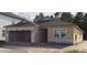 Exterior view of a home under construction, showcasing its frame, windows, and attached garage at 2292 Broadbrook Drive, St Cloud, FL 34771