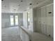 Interior of a home under construction, with drywall, concrete floor, and view of the yard through glass doors at 2292 Broadbrook Drive, St Cloud, FL 34771