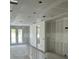 Interior view of a home under construction, featuring drywall, concrete floor, and a view of exterior through doors at 2292 Broadbrook Drive, St Cloud, FL 34771
