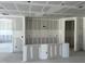 Interior view of a home under construction, featuring drywall, concrete floor, and a view of other rooms at 2292 Broadbrook Drive, St Cloud, FL 34771
