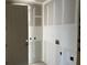 Awaiting appliances, this laundry room features fresh drywall and convenient hookups at 2292 Broadbrook Drive, St Cloud, FL 34771
