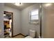 Small bathroom with standard toilet and view to another room through the doorway at 2334 W Doris St, Kissimmee, FL 34741