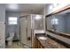 Bathroom featuring a toilet, single vanity with granite countertop, and enclosed shower at 2334 W Doris St, Kissimmee, FL 34741