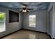 The bedroom features tiled floors, a fan, two windows, and a cloud painted ceiling at 2334 W Doris St, Kissimmee, FL 34741