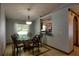 Cozy dining room features a glass-top table, elegant chandelier, and a pass-through to the kitchen at 2334 W Doris St, Kissimmee, FL 34741