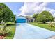 Charming single-story home with a well-maintained lawn and a long blue driveway provides a welcoming entrance at 2334 W Doris St, Kissimmee, FL 34741